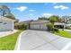 Inviting single-story home with an attached two-car garage and a well-maintained lawn at 17505 Se 100Th Ct, Summerfield, FL 34491