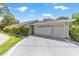 Charming single-story home featuring an attached two-car garage, manicured landscaping, and a spacious driveway at 17505 Se 100Th Ct, Summerfield, FL 34491