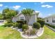 Attractive single-story home featuring lush landscaping and a meticulously kept garden at 17505 Se 100Th Ct, Summerfield, FL 34491