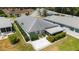 Aerial shot showcasing a cozy home featuring a screened lanai and a well-kept yard at 17505 Se 100Th Ct, Summerfield, FL 34491