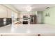 Kitchen with white cabinets, stainless steel fridge, and ceiling fan at 17505 Se 100Th Ct, Summerfield, FL 34491