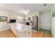 Kitchen area features stainless steel appliances and ceiling fan at 17505 Se 100Th Ct, Summerfield, FL 34491