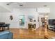 Bright living room with hardwood floors, a fireplace, and easy access to other rooms in the house at 17505 Se 100Th Ct, Summerfield, FL 34491