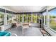 Enclosed sunroom features lots of natural light, neutral flooring, and room for seating at 17505 Se 100Th Ct, Summerfield, FL 34491