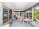 The sunroom features lots of windows for natural light, neutral flooring, and room to entertain guests at 17505 Se 100Th Ct, Summerfield, FL 34491