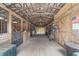 Inside of horse barn with wood beams, multiple stalls, and an open aisleway at 1781 Se 85Th Street Rd, Ocala, FL 34480