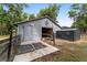 Barn doors open wide with a horse barn and storage shed at 1781 Se 85Th Street Rd, Ocala, FL 34480