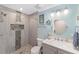 Bathroom featuring a shower, single vanity, and bright blue walls with decorative accents at 1781 Se 85Th Street Rd, Ocala, FL 34480