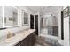 Bathroom featuring a double sink vanity, a glass enclosed shower and a walk-in closet at 1781 Se 85Th Street Rd, Ocala, FL 34480