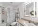Bathroom featuring an illuminated mirror, stylish vanity, and shower-tub combination at 1781 Se 85Th Street Rd, Ocala, FL 34480