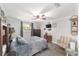 Comfortable bedroom with wood floors, ceiling fan, reading chair, dresser, and decorative accents at 1781 Se 85Th Street Rd, Ocala, FL 34480