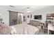Comfortable bedroom with a sliding barn door, ceiling fan, and a built-in TV at 1781 Se 85Th Street Rd, Ocala, FL 34480