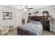 Bedroom features wood flooring, overhead fan, full bookcase headboard, and neutral paint at 1781 Se 85Th Street Rd, Ocala, FL 34480