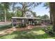 View of chicken coop with metal roof, small plants and walking path, and surrounded by trees at 1781 Se 85Th Street Rd, Ocala, FL 34480
