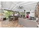 Charming covered brick patio featuring an outdoor dining and entertaining space with scenic backyard views at 1781 Se 85Th Street Rd, Ocala, FL 34480