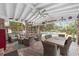 Enjoy this covered patio with comfortable seating, dining area, and views of the pool and spacious backyard at 1781 Se 85Th Street Rd, Ocala, FL 34480