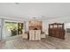 Elegant dining room with a brick fireplace, modern lighting, and access to screened in back porch at 1781 Se 85Th Street Rd, Ocala, FL 34480
