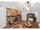 Dining room displays a brick fireplace with wooden mantel and decor at 1781 Se 85Th Street Rd, Ocala, FL 34480