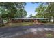 Sprawling ranch-style home with brick accents, mature trees, and well-maintained landscaping at 1781 Se 85Th Street Rd, Ocala, FL 34480