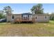 Charming home exterior showcasing a welcoming front porch and well-maintained lawn and landscaping at 1781 Se 85Th Street Rd, Ocala, FL 34480