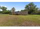 Home exterior with a small front porch, lush green grass, and lots of surrounding trees at 1781 Se 85Th Street Rd, Ocala, FL 34480