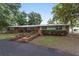 Single story home featuring brick accents, a metal roof and brick planter boxes at 1781 Se 85Th Street Rd, Ocala, FL 34480