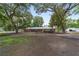 Large ranch-style house with a metal roof, mature trees, and an expansive front yard at 1781 Se 85Th Street Rd, Ocala, FL 34480