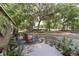 Charming front porch featuring rocking chairs, potted plants, and a view of the front yard and mature trees at 1781 Se 85Th Street Rd, Ocala, FL 34480