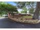 Charming brick home with flowerbeds and mature trees lining the front yard at 1781 Se 85Th Street Rd, Ocala, FL 34480