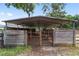 Covered horse shelter with wooden walls and a metal roof, offering protection from the elements at 1781 Se 85Th Street Rd, Ocala, FL 34480