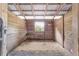 Inside a horse stall, natural light streams through the barred window, illuminating the wood-paneled walls at 1781 Se 85Th Street Rd, Ocala, FL 34480