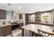 Modern kitchen with stainless steel appliances, dark wood cabinetry, and a cozy breakfast bar at 1781 Se 85Th Street Rd, Ocala, FL 34480
