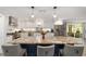Open kitchen includes an island, stainless steel fridge and granite countertops at 1781 Se 85Th Street Rd, Ocala, FL 34480