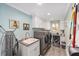 This laundry room features modern washer and dryer units, ample cabinet space, and stylish gray flooring at 1781 Se 85Th Street Rd, Ocala, FL 34480
