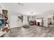 Open-concept living room featuring stylish wood-look floors, neutral paint, and a ceiling fan at 1781 Se 85Th Street Rd, Ocala, FL 34480
