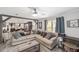 Bright living room showcasing an open floor plan, wood beam details, and lots of comfortable seating at 1781 Se 85Th Street Rd, Ocala, FL 34480