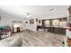 Spacious living room with stylish wood floors and a view of the open kitchen, creating an inviting atmosphere at 1781 Se 85Th Street Rd, Ocala, FL 34480
