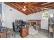 Comfortable living area features a wood ceiling, brick fireplace, study, and exterior views at 1781 Se 85Th Street Rd, Ocala, FL 34480