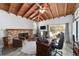 Living room featuring wood-planked vaulted ceiling, brick fireplace, media area, and outdoor views at 1781 Se 85Th Street Rd, Ocala, FL 34480