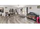 Spacious living room showcasing wood-look floors, natural light, and ample space for seating at 1781 Se 85Th Street Rd, Ocala, FL 34480