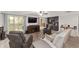 Comfortable living room with a built-in bar area, bay window, and leather seating for relaxed entertaining at 1781 Se 85Th Street Rd, Ocala, FL 34480