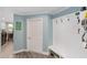 A well-organized mudroom boasts a white bench with storage and convenient hooks for coats and accessories at 1781 Se 85Th Street Rd, Ocala, FL 34480