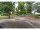 Expansive green pasture with mature trees and a dark wooden fence, ideal for horses to graze and roam freely at 1781 Se 85Th Street Rd, Ocala, FL 34480