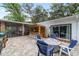 Paver patio with wooden bar, seating, and convenient access to the screened lanai at 1781 Se 85Th Street Rd, Ocala, FL 34480