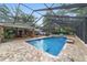 Enjoy the screened-in pool and patio area with lush greenery and an outdoor dining area nearby at 1781 Se 85Th Street Rd, Ocala, FL 34480