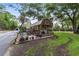 Charming shed with a cozy porch, surrounded by lush landscaping and manicured lawn, perfect for relaxing at 1781 Se 85Th Street Rd, Ocala, FL 34480
