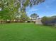Expansive backyard featuring lush green grass and mature trees, offering a serene and private outdoor space for relaxation at 2340 Ne 44Th St, Ocala, FL 34479