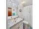 Bathroom featuring vanity with marbled countertops, a large mirror, and a shower with a fun, star-themed curtain at 2340 Ne 44Th St, Ocala, FL 34479