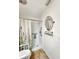 Walk-in shower featuring tile floors, a floral curtain, grab bars, and an overhead shower head at 2340 Ne 44Th St, Ocala, FL 34479