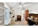 Bedroom featuring a built-in shelving, closet with mirrored doors, desk, and a ceiling fan at 2340 Ne 44Th St, Ocala, FL 34479